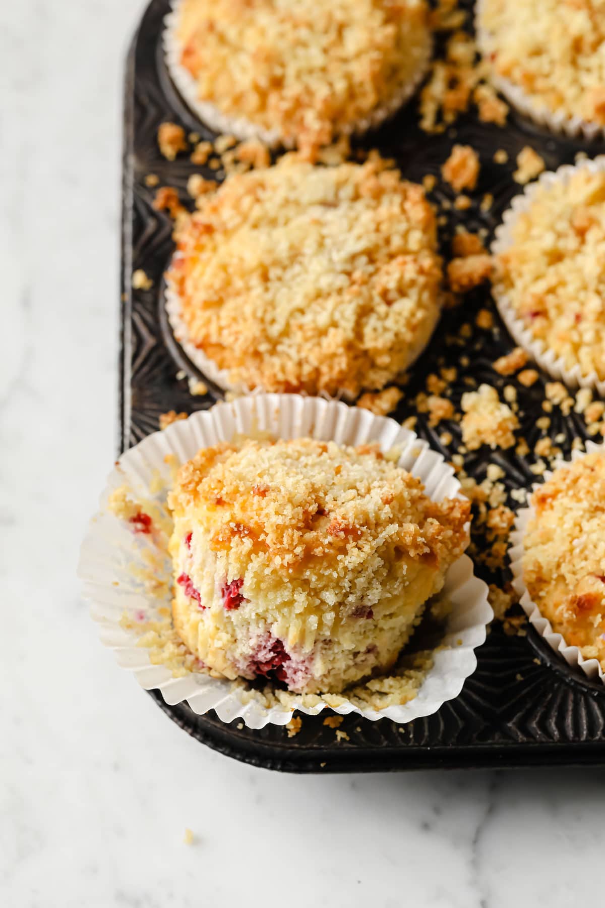 a raspberry muffin taken out of its paper case