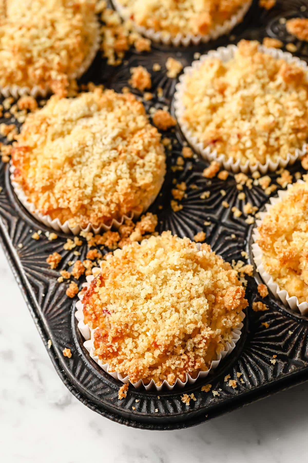 raspberry streusel muffins in a muffin pan