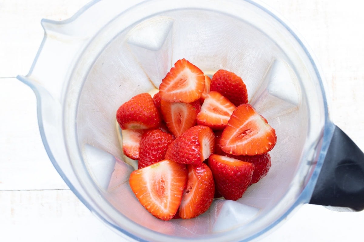 sliced strawberries in a blender jug
