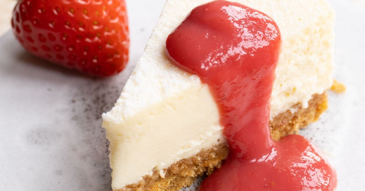 strawberry sauce on a cheesecake slice