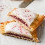 a keto pop tart with raspberry filling and icing sliced in half
