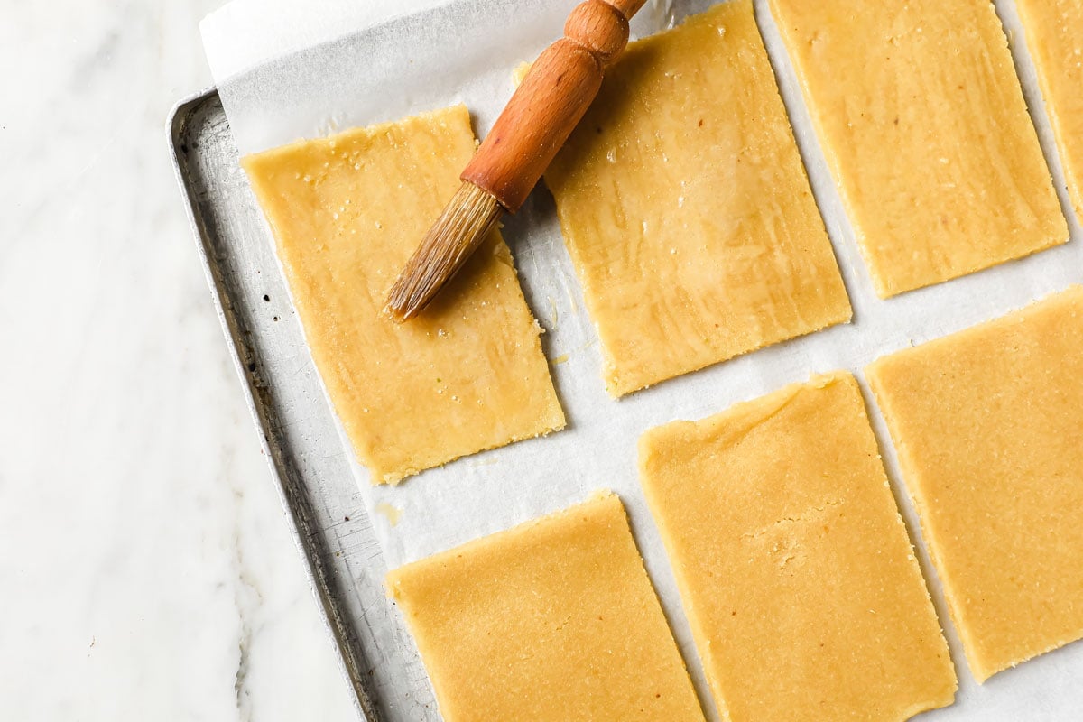 brushing pastry rectangles with egg wash
