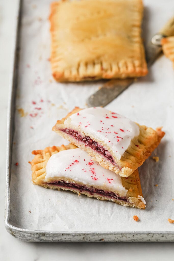 a sliced pop tart filled with raspberry jam and topped with a sugar free icing