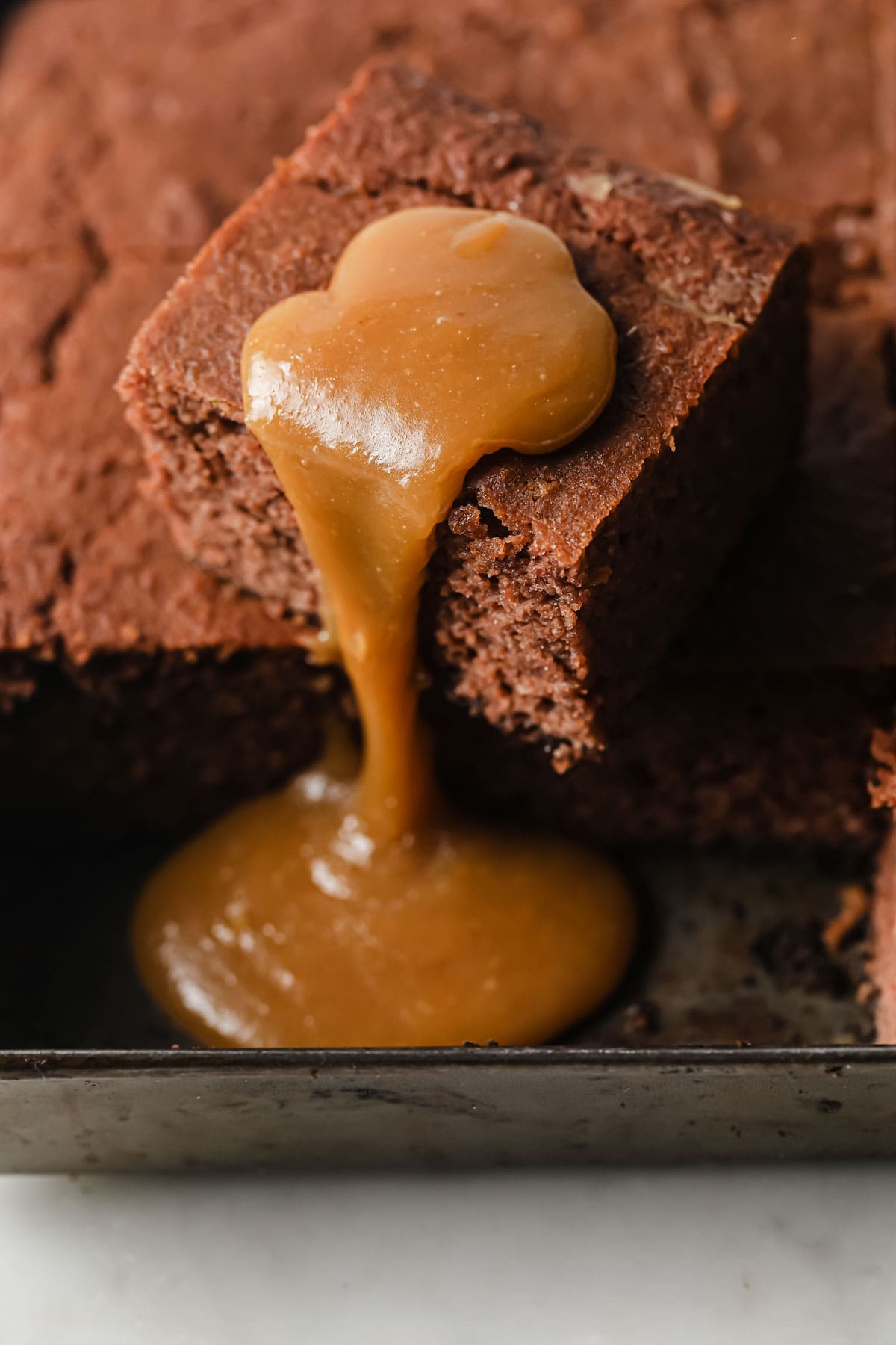 a square of keto sticky toffee pudding with caramel sauce