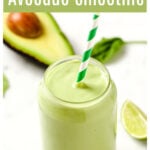a glass of avocado smoothie with a straw