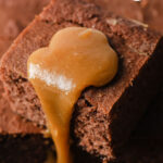 closeup of a sticky toffee pudding square with toffee sauce