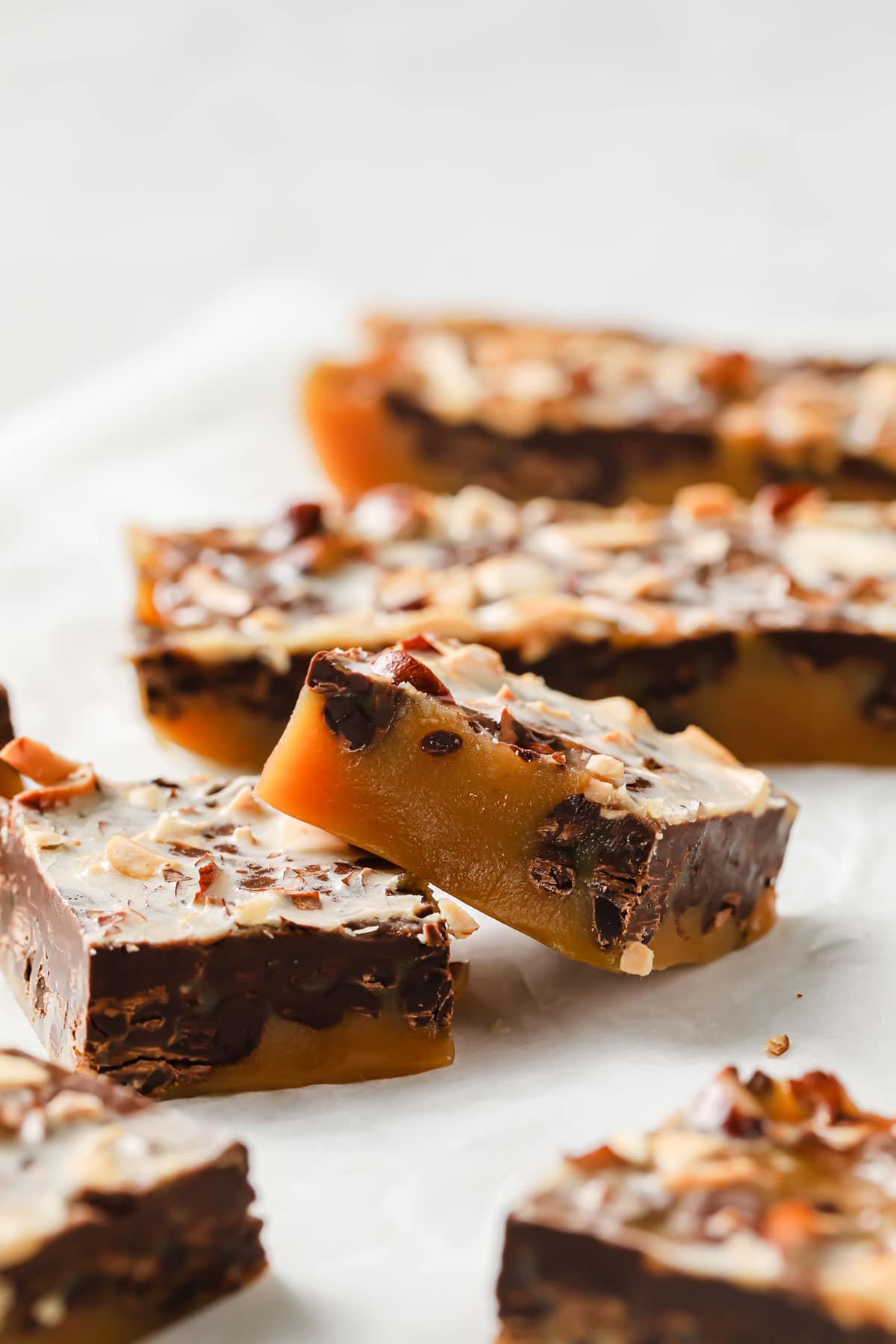 toffee squares with chocolate on parchment paper
