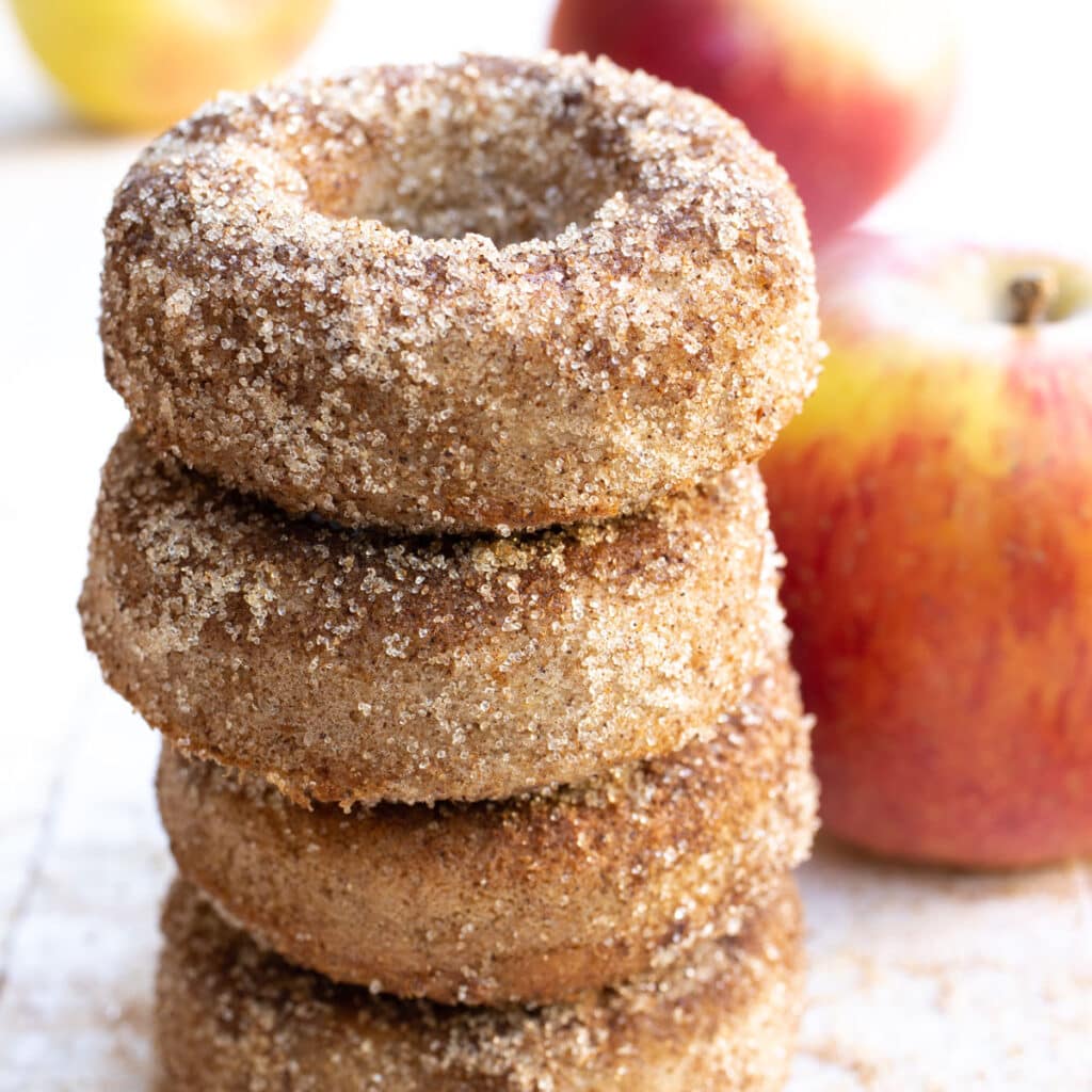 a stack of keto apple cider donuts coated in cinnamon "sugar"