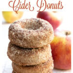 a stack of apple cider donuts coated in a cinnamon and sweetener mix