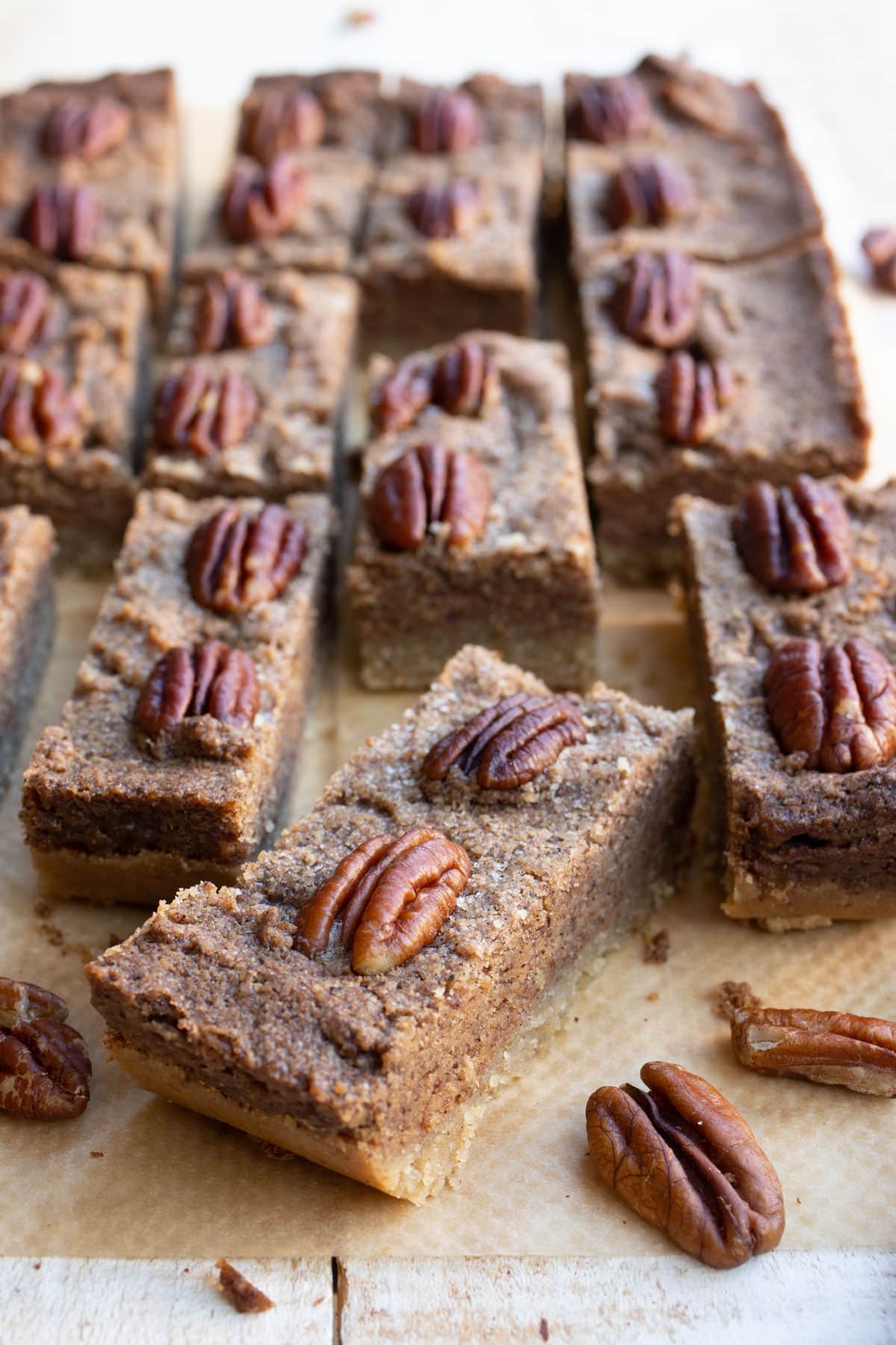 A pecan bar topped with pecan halves.