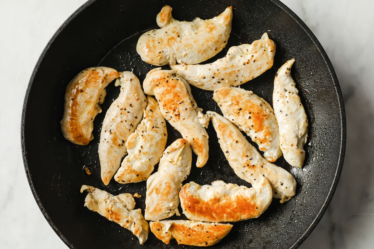 frying chicken fillets in a pan