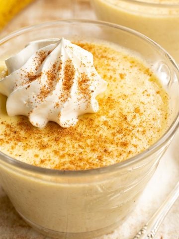 a dessert up of keto banana pudding with a whipped cream topping