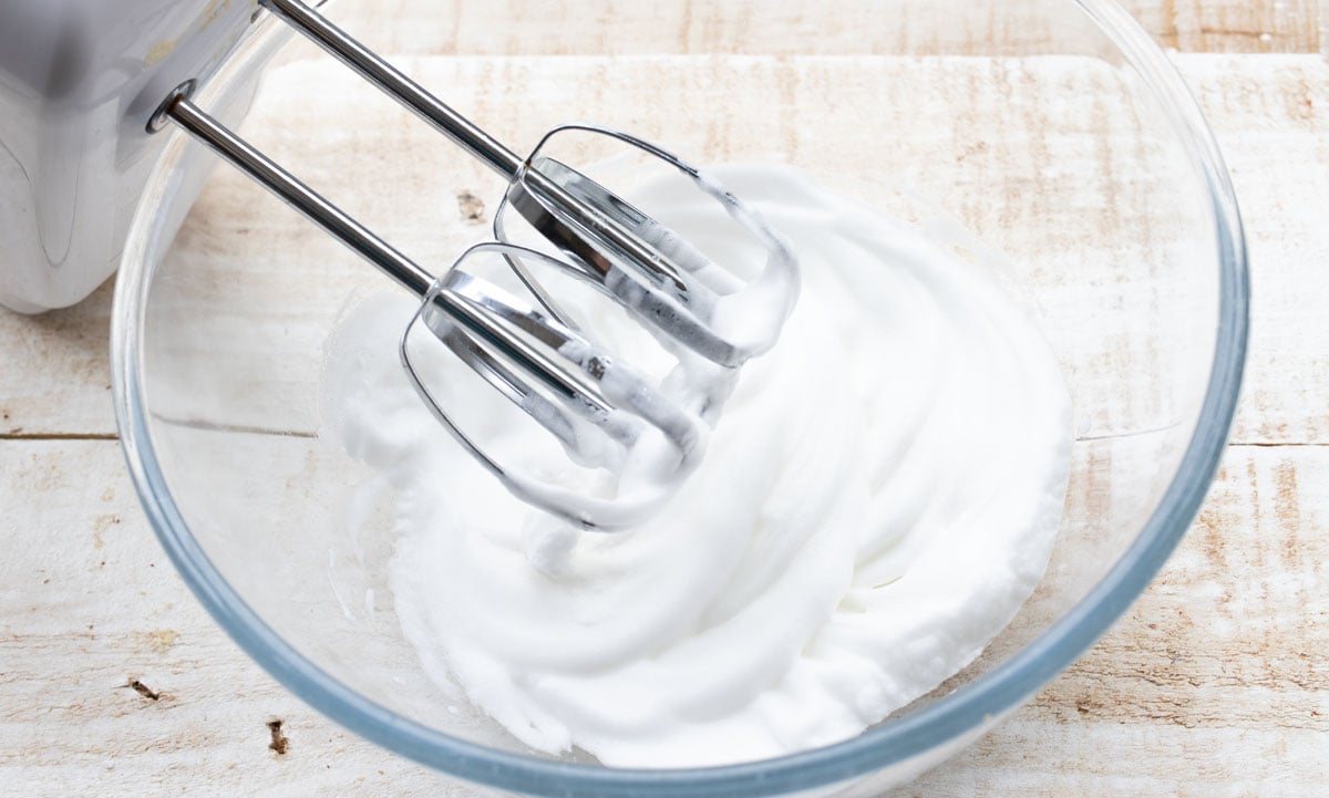 whisked egg white in a bowl and a mixer