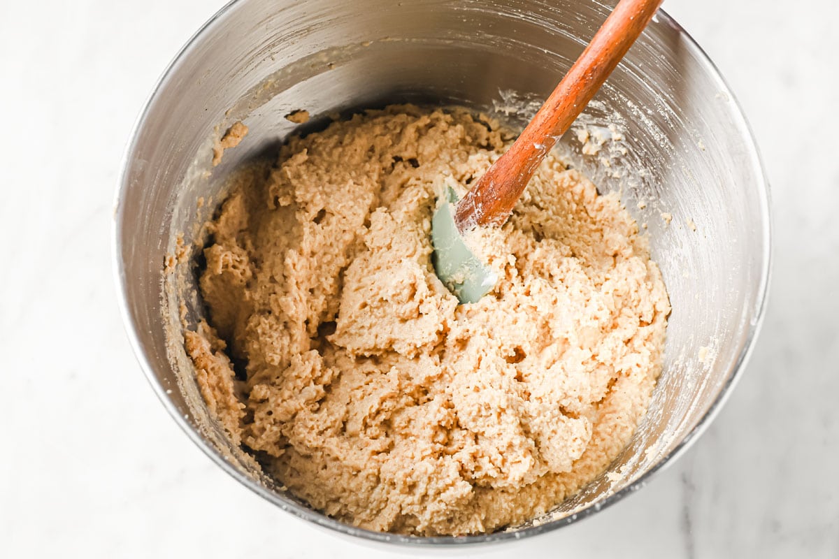 Cake batter in a bowl with a spatula.