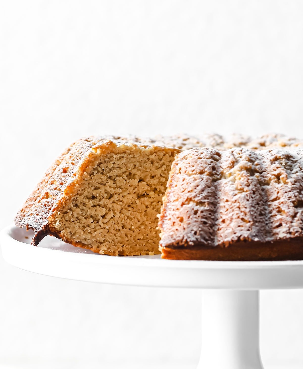 A gingerbread cake on a cake stand. 