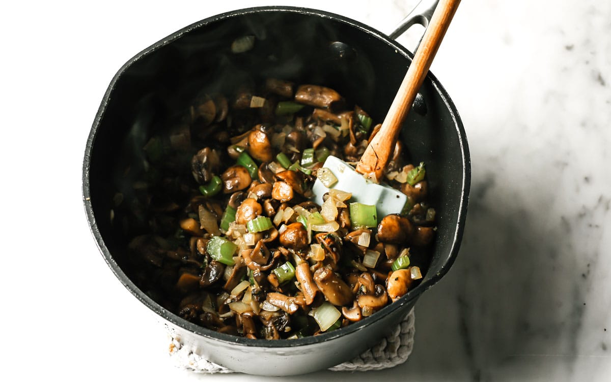 mushrooms, celery and onion in a saucepan