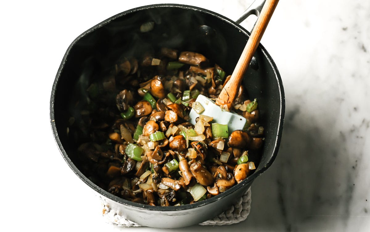 Mushrooms, celery and onion in a pot.