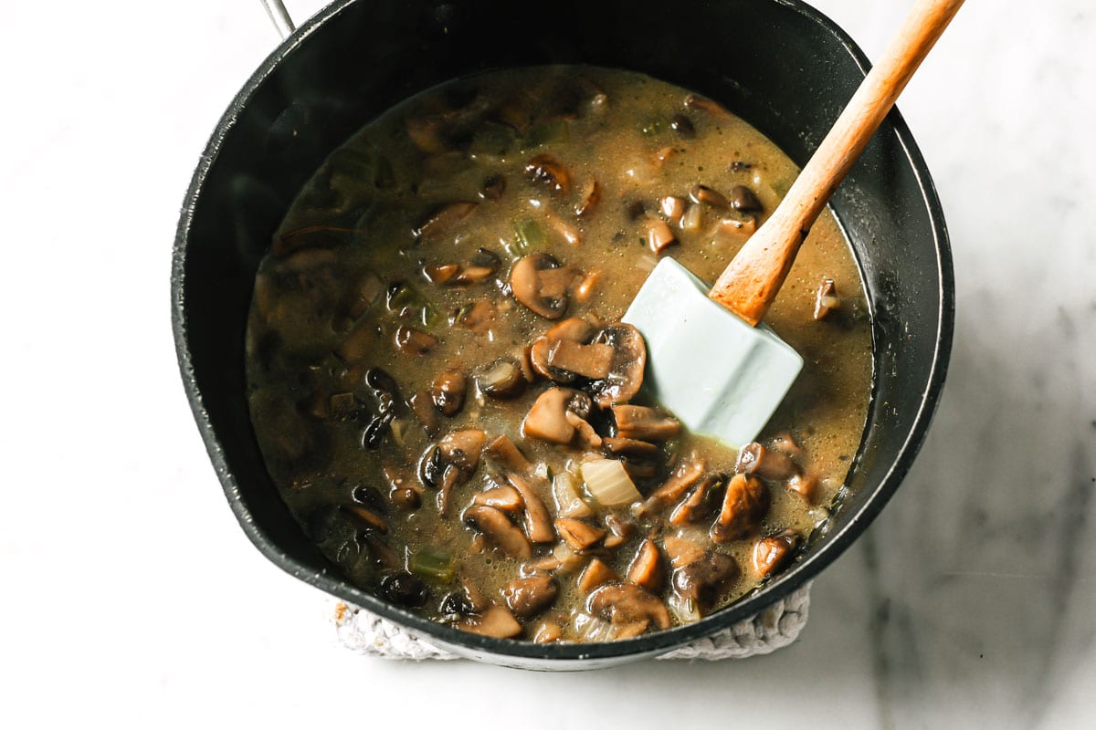 mushrooms in a saucepan and a spatula