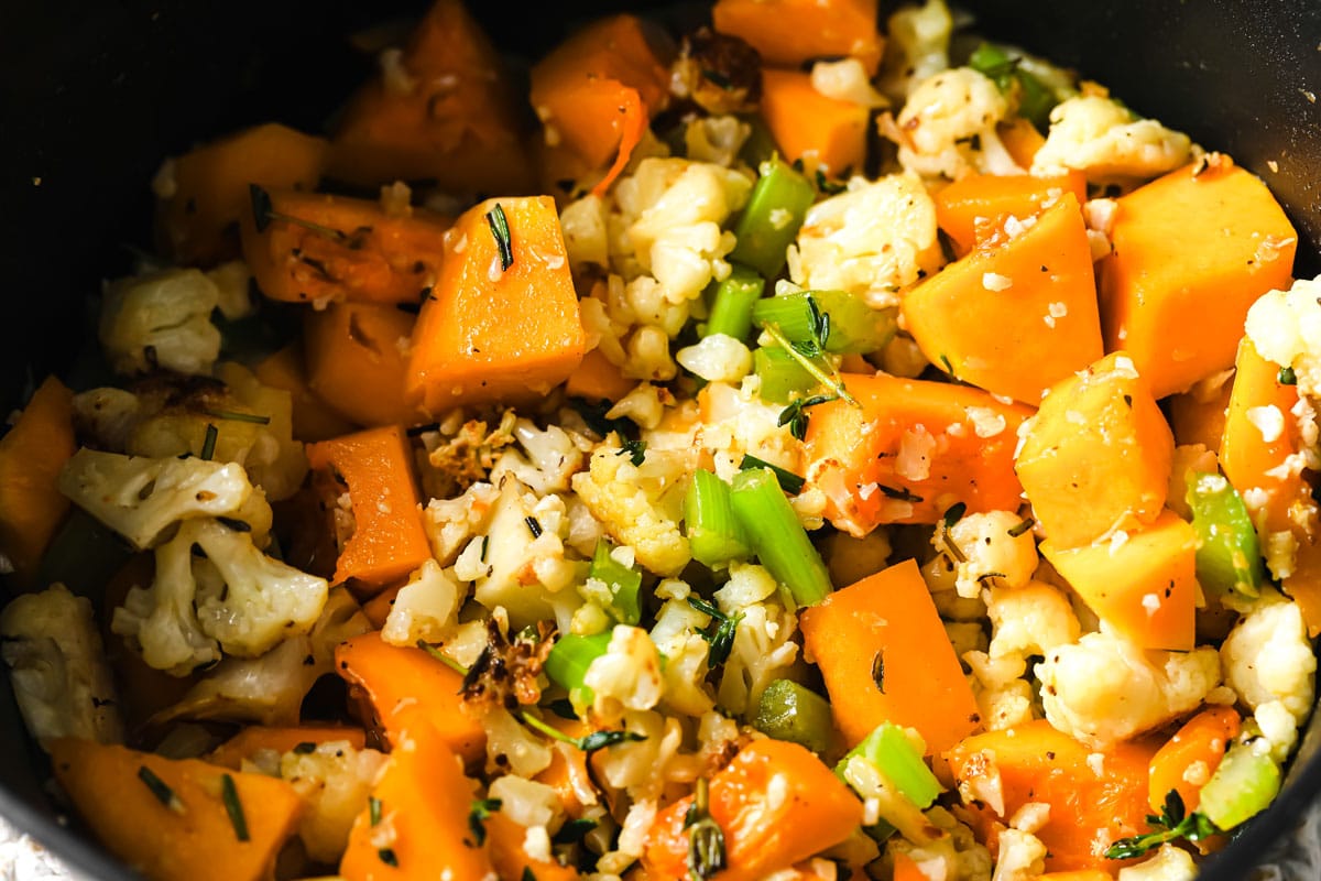 butternut squash, cauliflower, celery and spices in a saucepan
