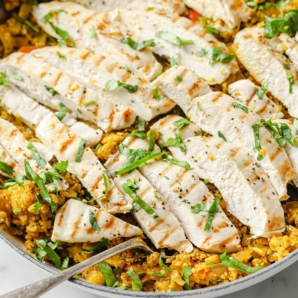 sliced chicken breast on Indian cauliflower rice