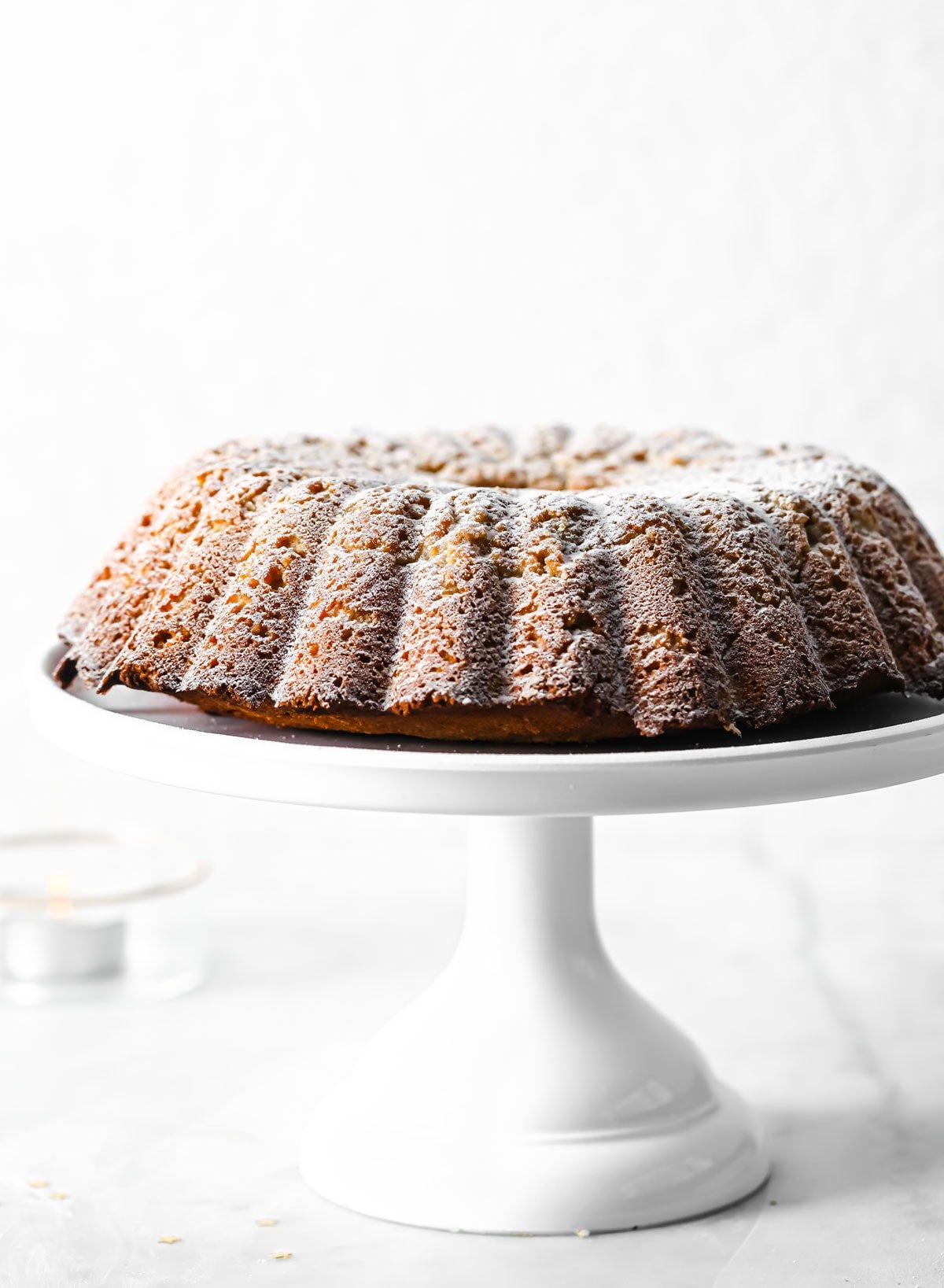 a Keto Gingerbread Cake on a cake stand
