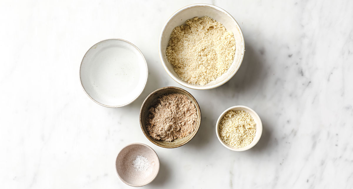 Ingredients to make chia seed crackers, measured into bowls. 