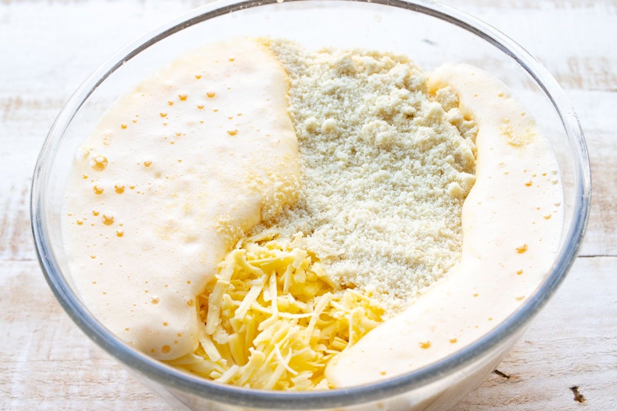 whisked egg, grated cheese and almond flour in a bowl