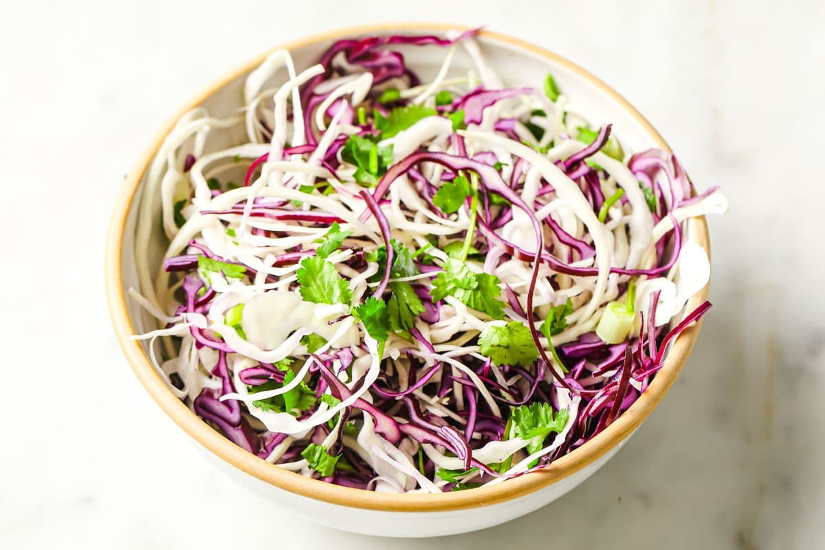 sliced cabbage and parsley in a bowl