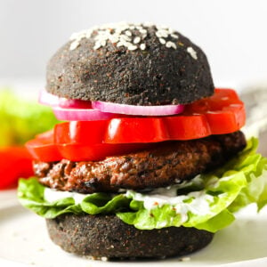 A hamburger with a black bun