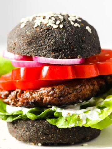 A hamburger with a black bun