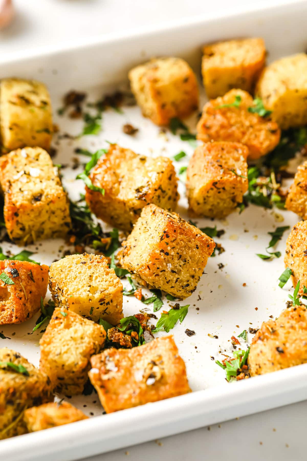 Low carb croutons in a tray with chopped parsley