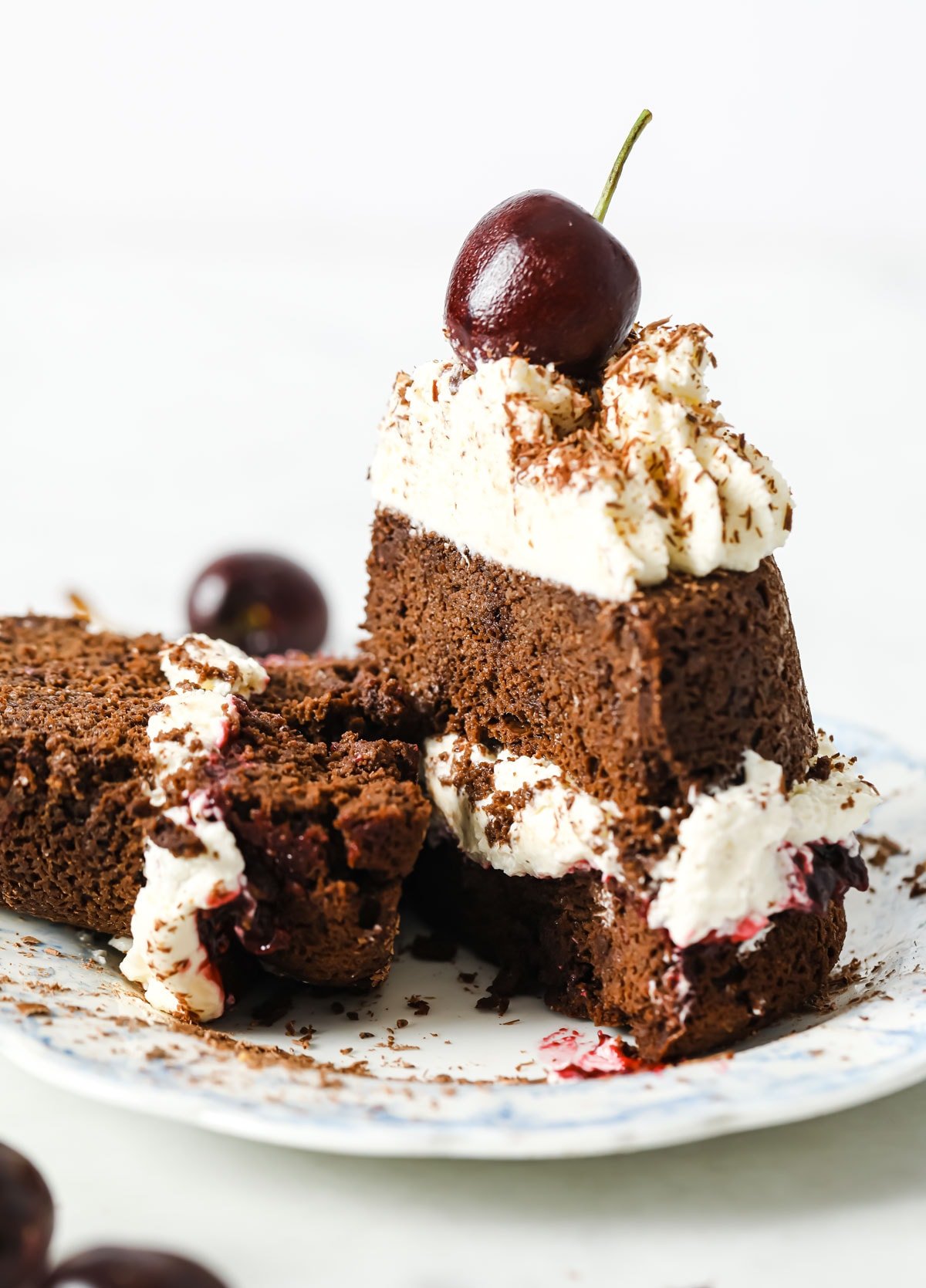 cake sliced in half with cream and jam in the middle