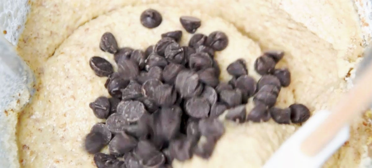 stirring chocolate chips into the batter