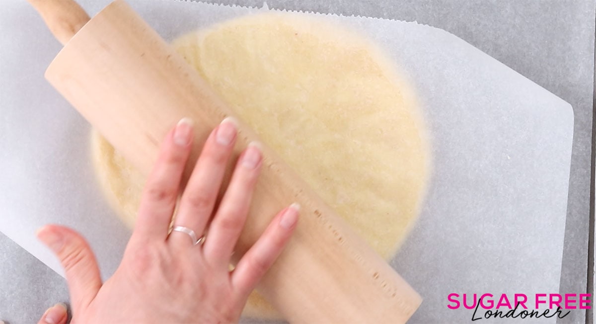 rolling out the dough between 2 pieces of parchment paper