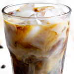 A glass with iced coffee and ice cubes