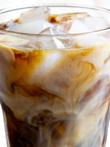 A glass with iced coffee and ice cubes