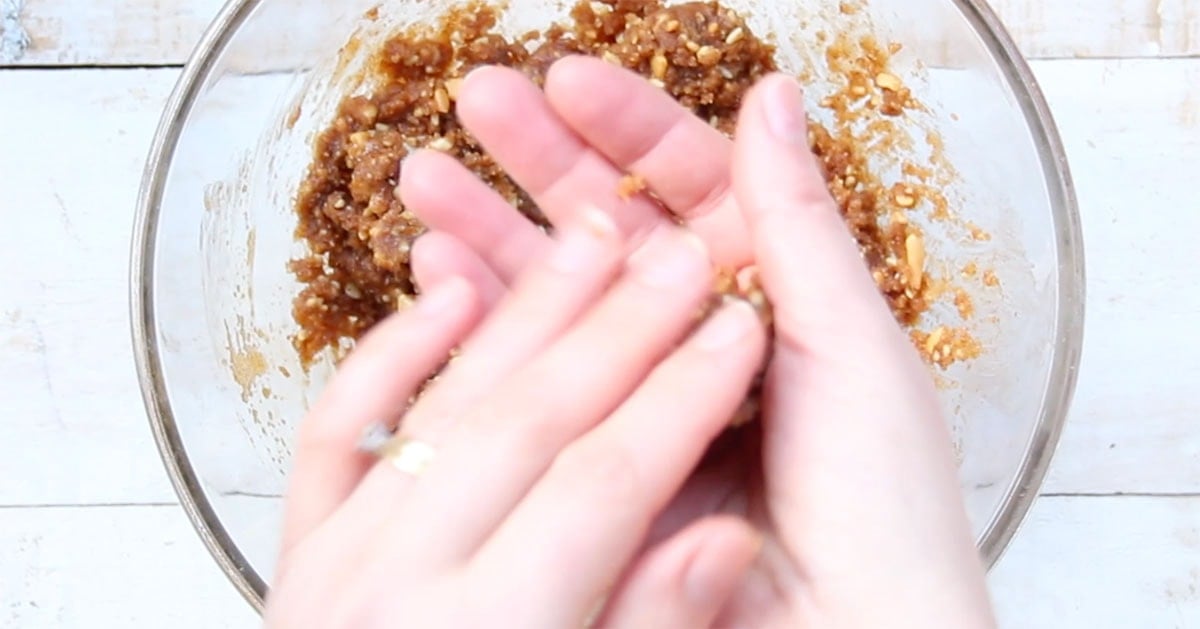Rolling a ball of cookie dough with hands.