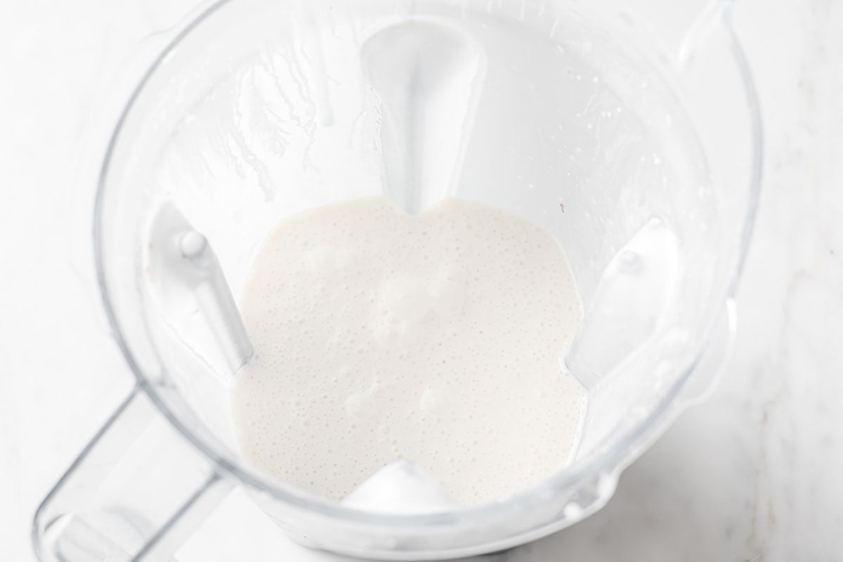 blended almond milk mix in a blender jug