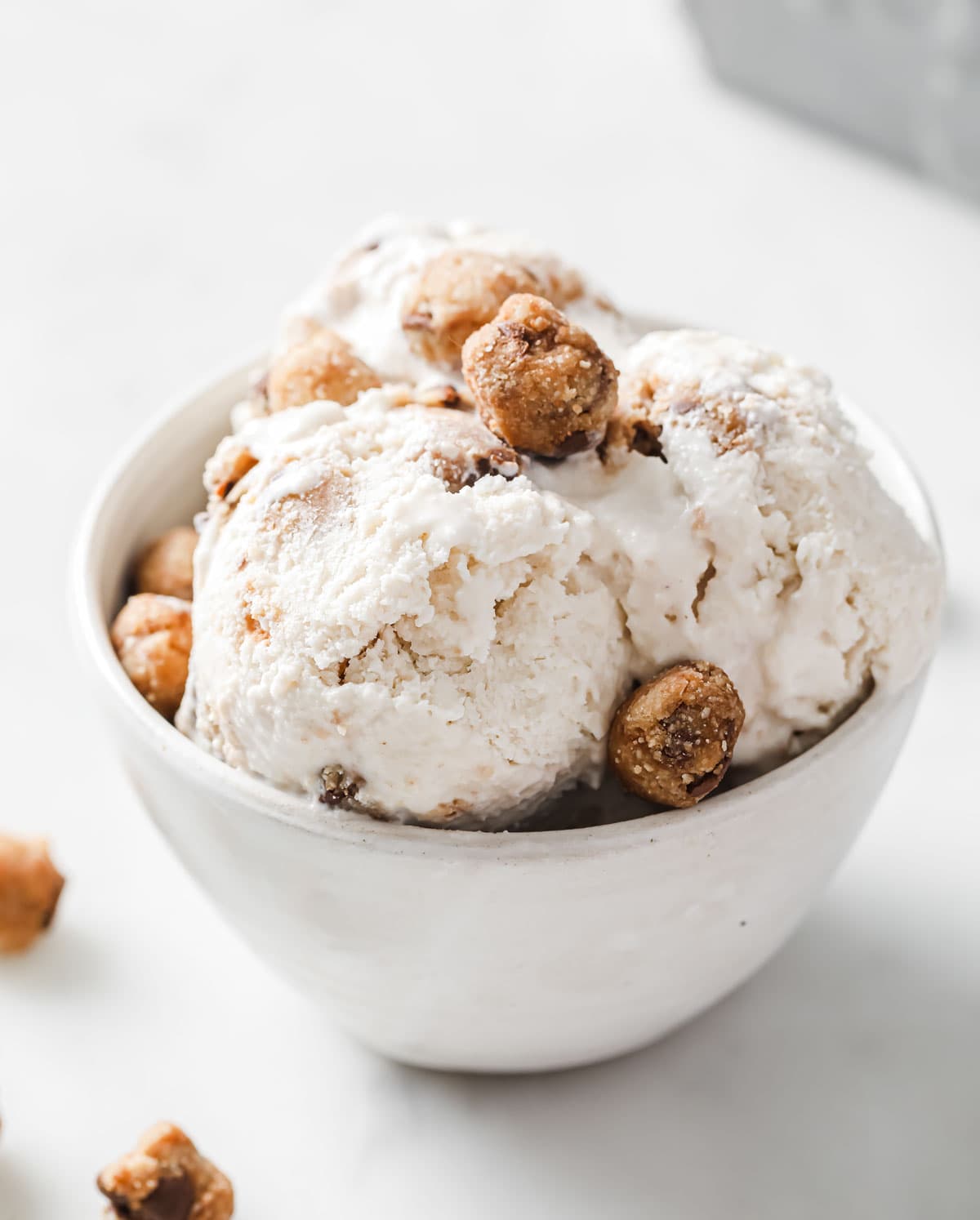 Ice cream scoops in a bowl with cookie dough balls