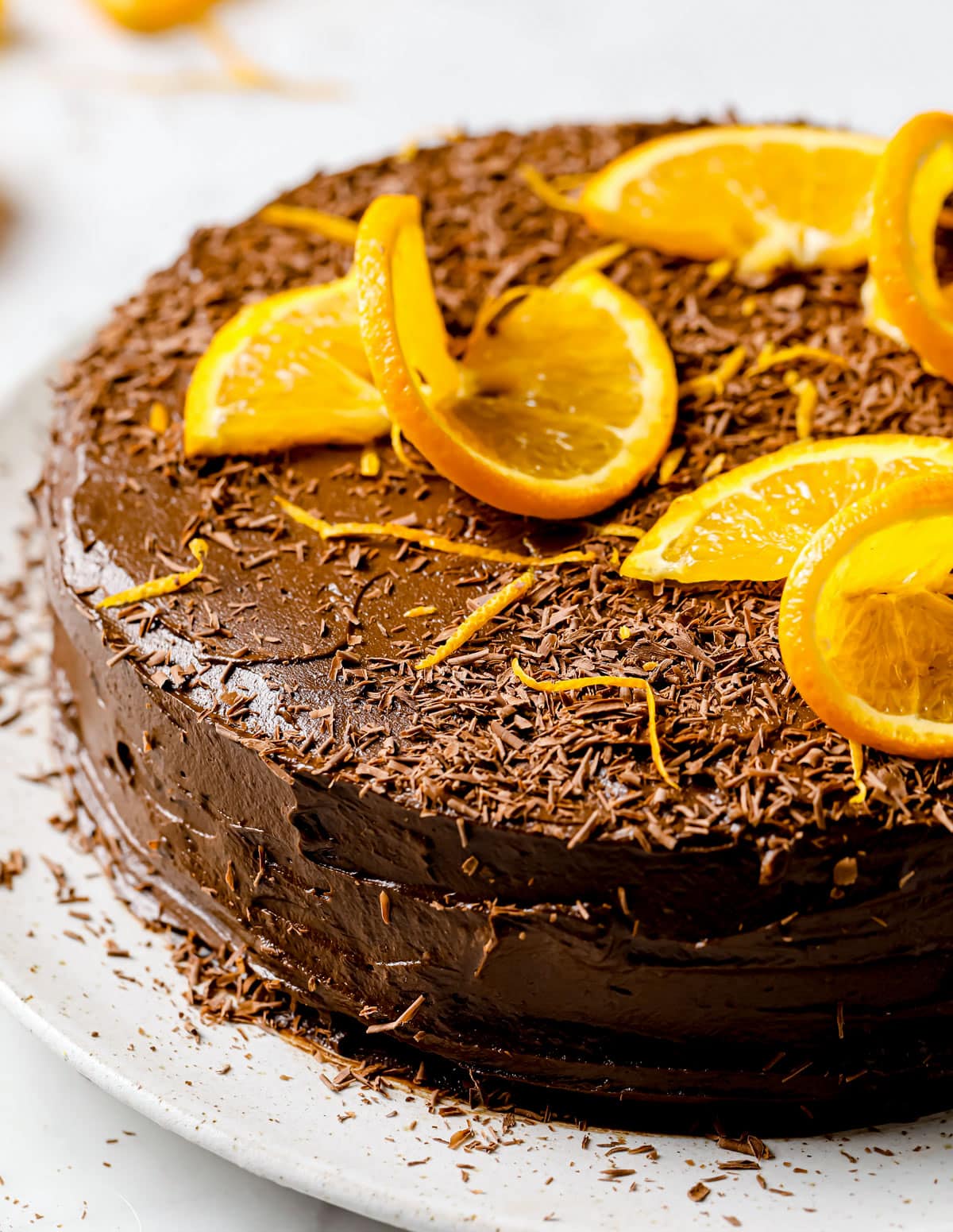 A low carb chocolate cake with orange slices on a plate