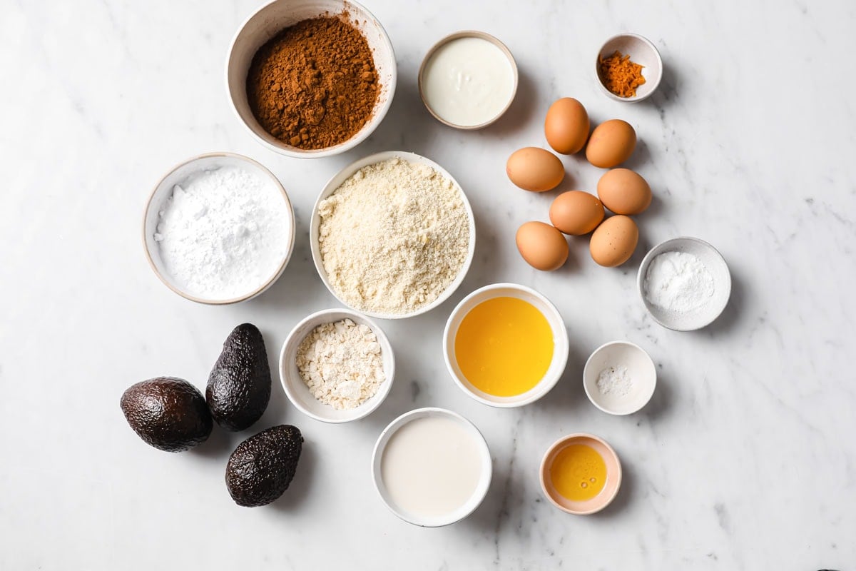 Ingredients for a chocolate orange cake measured into bowls