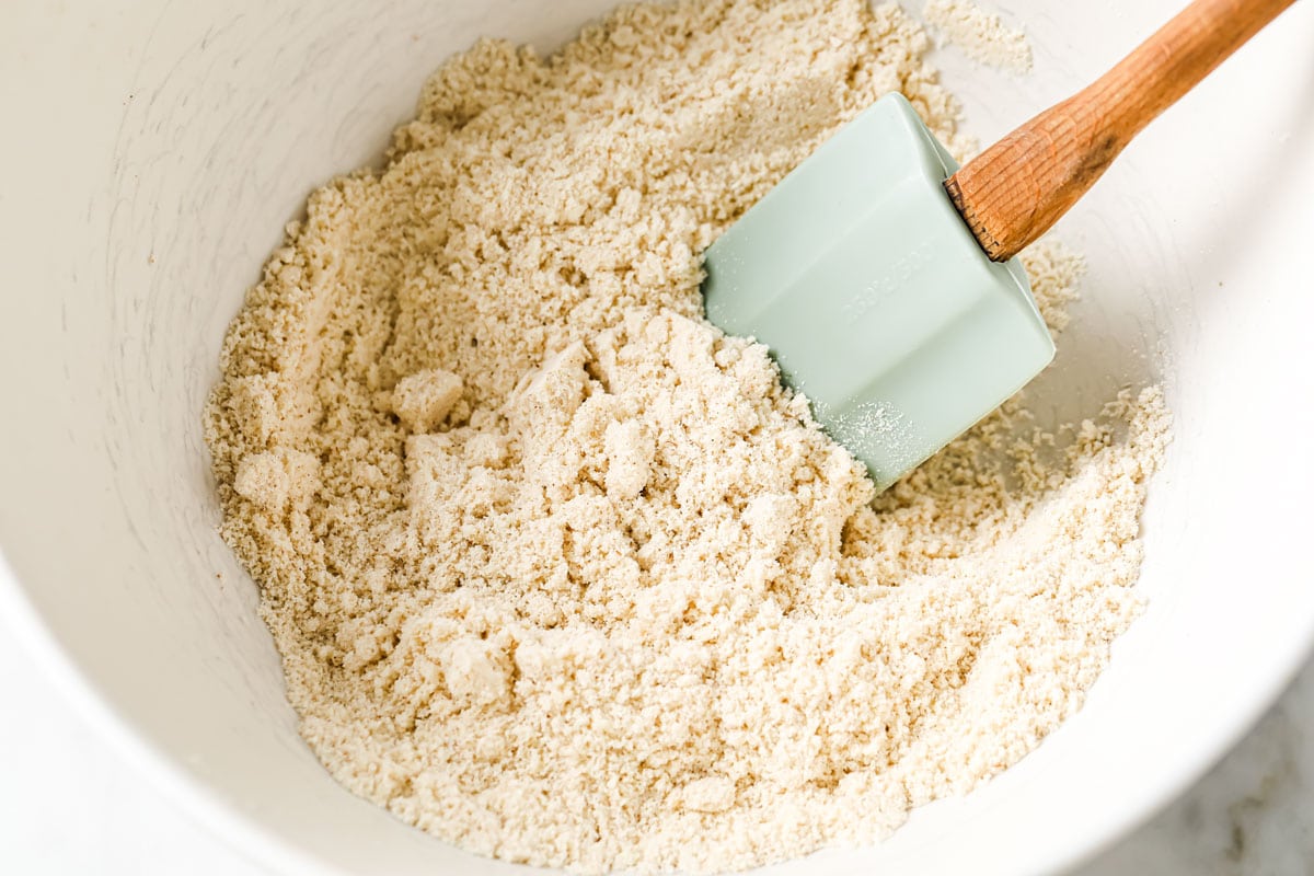 Almond flour in a bowl and a spatula.
