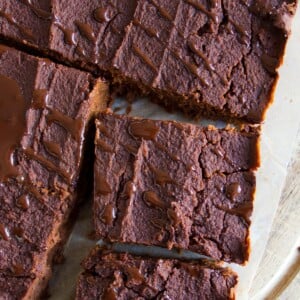 Pumpkin brownie squares drizzled with chocolate sauce.