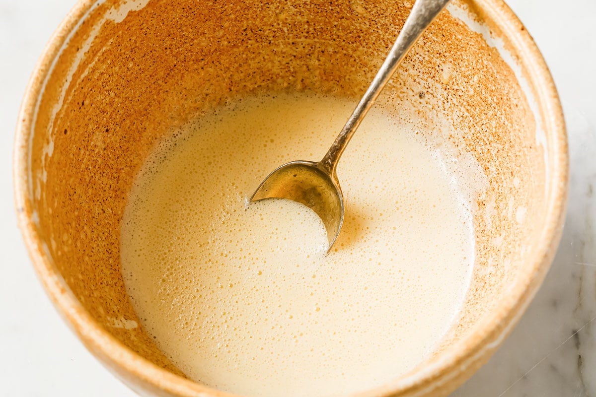 Mixing wet ingredients in a bowl with a spoon