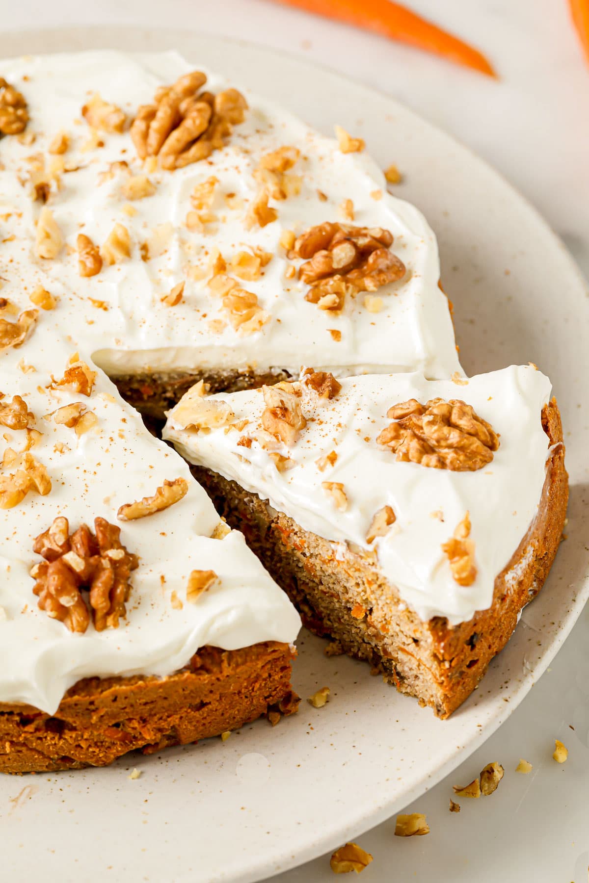 A carrot cake topped with greek yoghurt frosting.