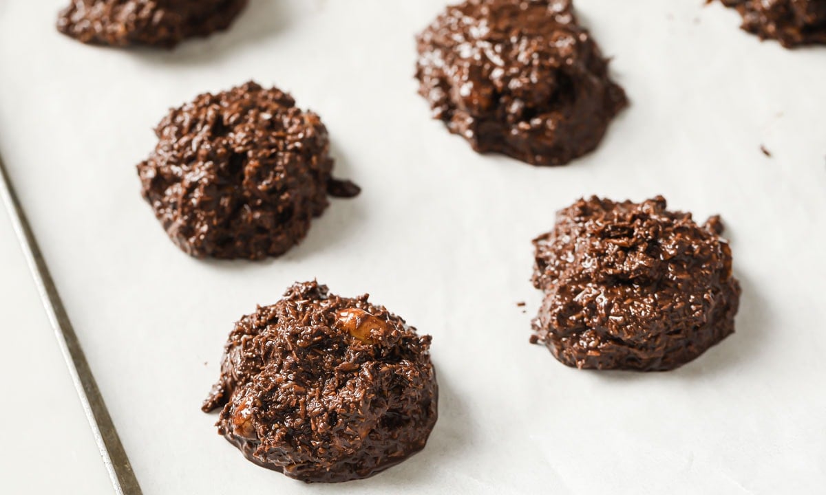 Cookies portioned out on parchment paper.