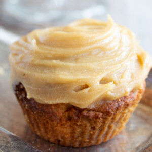 A gingerbread cupcake with frosting.