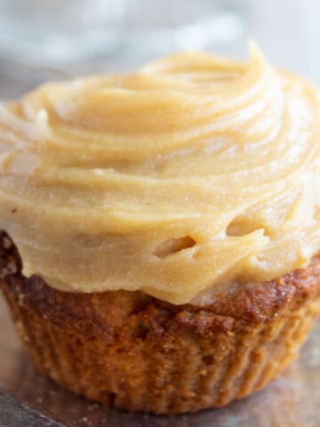 A gingerbread cupcake with frosting.