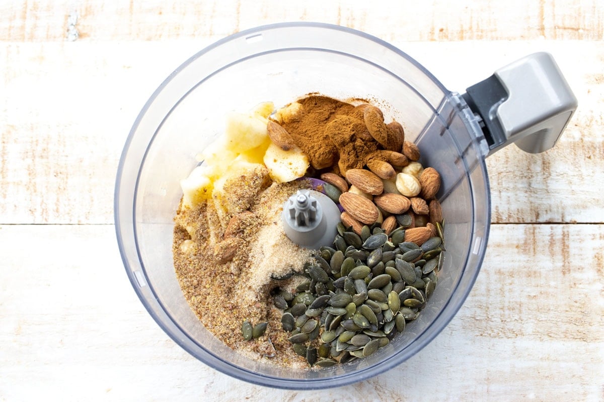 Unblended ingredients in a food processor bowl.