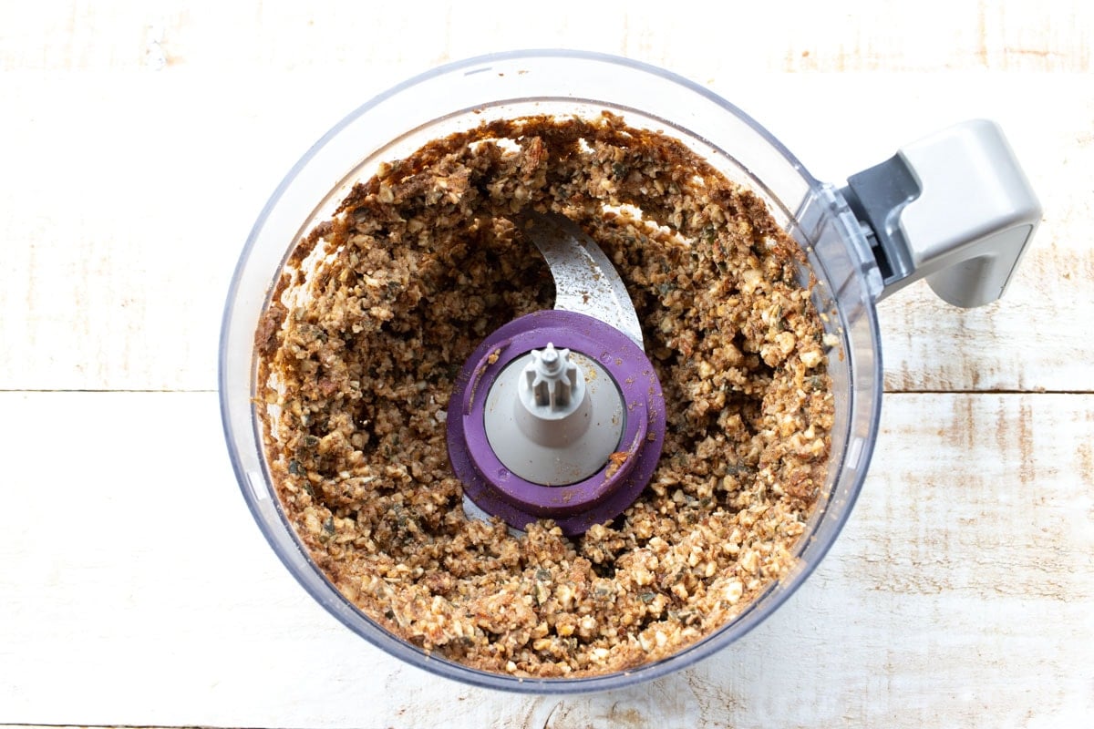 Blended ingredients in a food processor bowl.